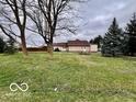 A view of the spacious backyard featuring a glimpse of the house, showing outdoor space at 7154 S 325 W, Jamestown, IN 46147