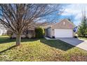 Charming brick home with a two-car garage and long driveway on a sunny day at 7260 Blue Ridge Dr, Noblesville, IN 46062