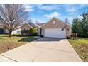 Charming brick home with a two-car garage and long driveway on a sunny day at 7260 Blue Ridge Dr, Noblesville, IN 46062