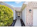 Inviting entrance to home featuring a storm door and manicured landscaping at 7260 Blue Ridge Dr, Noblesville, IN 46062