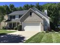 Charming two-story home with a large two-car garage and well-manicured lawn at 7336 Hardin Oak Dr, Noblesville, IN 46062