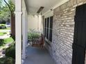 Close-up of a cozy wooden porch swing on a charming brick-accented porch at 7336 Hardin Oak Dr, Noblesville, IN 46062