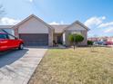 Inviting one-story residence with a tidy front yard, featuring a well-kept lawn and an attached garage at 7404 Oak Mill Ct, Indianapolis, IN 46217