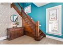 Entryway with wooden staircase, decorative wallpaper and beautiful stain glass window at 774 Woodruff Pl E Dr, Indianapolis, IN 46201