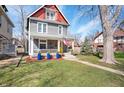 Charming two-story home featuring a well-manicured lawn, sidewalk, and lush yard at 774 Woodruff Pl E Dr, Indianapolis, IN 46201