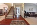Inviting foyer featuring hardwood floors, staircase, and an open view into other living spaces at 7984 S Deer Lake Dr, Nineveh, IN 46164