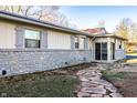 Charming home with stone accents, neutral siding, shutters, and a stone pathway leading to the entrance at 9619 E Southport Rd, Indianapolis, IN 46259