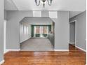 Open-concept layout showcasing hardwood floors leading into a dining room with built-ins and natural light at 108 Parkridge Dr, Danville, IN 46122
