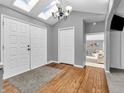 Welcoming foyer with wood floors, skylight and double doors, leading into a naturally lit living space at 108 Parkridge Dr, Danville, IN 46122