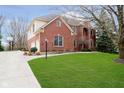 Beautiful brick home featuring an attached garage, well-manicured lawn and driveway at 11733 Creekstone Way, Zionsville, IN 46077
