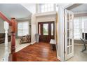 Elegant foyer with hardwood floors, a high ceiling, and a grand staircase with natural lighting at 11733 Creekstone Way, Zionsville, IN 46077