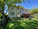 Spacious backyard showcasing the home's exterior, mature trees, and well-manicured lawn at 11967 Windpointe Pass, Carmel, IN 46033