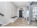 Inviting entryway with coat hooks, bench, and a modern sliding barn door at 1283 Cliff View Dr, Westfield, IN 46074
