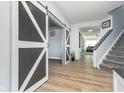 Hallway featuring a decorative sliding barn door and stylish flooring at 1283 Cliff View Dr, Westfield, IN 46074