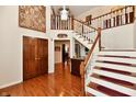 Grand foyer featuring hardwood floors, a staircase, and elegant decor at 12917 Brighton Ln, Carmel, IN 46032