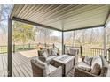 Relaxing covered outdoor seating area with views of the peaceful pond and trees at 1527 Canyon Oak Ln, Columbus, IN 47201