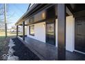 Close-up of the front porch with black columns and a secure entry door at 1808 Raible Ave, Anderson, IN 46011