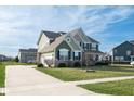 Charming home featuring a long driveway, attached garage, and a well-kept lawn at 2314 Angelina Way, Greenwood, IN 46143