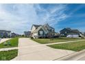 Well-maintained home with a long driveway, attached garage, and a lush green lawn at 2314 Angelina Way, Greenwood, IN 46143