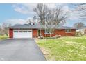 Beautiful brick ranch with attached garage and a paved driveway at 2315 Cardinal Dr, Indianapolis, IN 46227