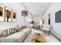 Open-concept living room boasts a cozy couch, modern decor, and a view into the dining area and kitchen at 238 N Tacoma Ave, Indianapolis, IN 46201