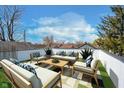 Relax on this rooftop deck with seating, stylish pillows, and a coffee table with a neighborhood view at 238 N Tacoma Ave, Indianapolis, IN 46201