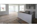 Unfinished new construction kitchen with gray cabinets, a large island, and bright natural light at 4016 Bozeman Way, Bargersville, IN 46106