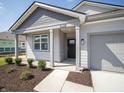 Charming single-story home with a gray exterior, well-manicured lawn, and a covered front porch at 5152 Cartland Dr, Indianapolis, IN 46239