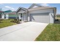 Charming single-story home with a gray exterior, well-manicured lawn, and an attached two-car garage at 5152 Cartland Dr, Indianapolis, IN 46239