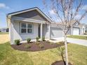 Charming single-story home with a gray exterior, well-manicured lawn, and an attached two-car garage at 5152 Cartland Dr, Indianapolis, IN 46239