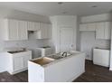 Spacious kitchen featuring white cabinets, a center island, and hardwood floors at 5210 Cartland Dr, Indianapolis, IN 46239