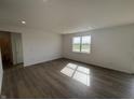Spacious living room featuring hardwood floors and a large window at 5210 Cartland Dr, Indianapolis, IN 46239