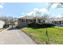 Attractive house with a driveway, lawn, and neatly trimmed bushes showcasing curb appeal at 5721 Indianola Ave, Indianapolis, IN 46220