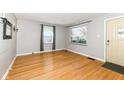 Bright living room featuring hardwood floors, neutral walls, and ample natural light from two windows at 5721 Indianola Ave, Indianapolis, IN 46220
