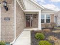 Close-up view of the front entrance featuring a wreath on the door and manicured landscaping at 5832 Lyster Ln, Indianapolis, IN 46239