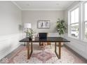 Bright office space with a large desk, stylish decor, and a large window for natural light at 5832 Lyster Ln, Indianapolis, IN 46239