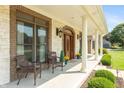 Inviting front porch with decorative stone columns and arched wood doorway at 6017 Quail Creek Blvd, Indianapolis, IN 46237