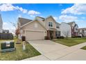 View of house with a two-car garage, brick accents, and well-maintained lawn and landscape at 6075 Meadowview Dr, Whitestown, IN 46075