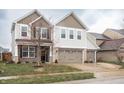 Charming two-story home with three-car garage, brick accents, and a well-manicured lawn at 6345 Meadowview Dr, Whitestown, IN 46075