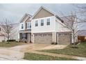 Charming two-story home with three-car garage, brick accents, and a well-manicured lawn at 6345 Meadowview Dr, Whitestown, IN 46075