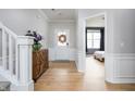 Inviting foyer featuring hardwood floors, a decorative wreath, and a glimpse of a bedroom at 6345 Meadowview Dr, Whitestown, IN 46075