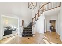 Bright foyer features a grand staircase with decorative carpet and tile flooring at 6516 Shamel Dr, Indianapolis, IN 46278