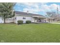 Cozy single-story home featuring vinyl siding, a covered porch, and a lovely front lawn at 654 Park Dr, Greenwood, IN 46143