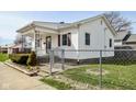 Cozy home with a fenced yard and a welcoming front porch at 858 E Berwyn St, Indianapolis, IN 46203