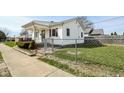 Cozy home with a fenced yard and a welcoming front porch at 858 E Berwyn St, Indianapolis, IN 46203