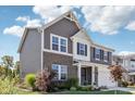 Beautiful two-story home with brick and gray siding, showcasing well-maintained landscaping and an attached two car garage at 9723 Violet Cir, Indianapolis, IN 46239