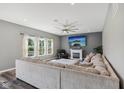 Bright living room with a fireplace, a large comfortable sectional sofa, and three large windows allowing natural light at 9723 Violet Cir, Indianapolis, IN 46239