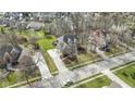 View of a house with an extended driveway and a basketball hoop on a well-manicured lawn at 9931 Woodlands Dr, Fishers, IN 46037