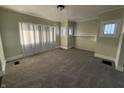 Bright living room featuring plush carpeting, ample natural light, and neutral paint tones at 1124 Victory Ct, Anderson, IN 46016