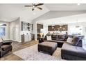 Open-concept living room with a wet bar, hardwood floors, and plenty of natural light at 16075 Cobbs Crk Ln, Noblesville, IN 46060